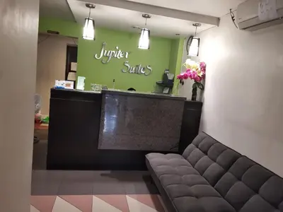 a waiting room with a bench in a store at Jupiter Suites in Manila