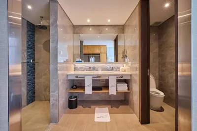 a bathroom with a sink and a toilet at Hotel H2O in Manila