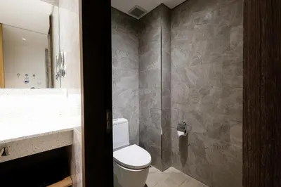 a bathroom with a toilet and a sink and a shower at Hotel H2O in Manila