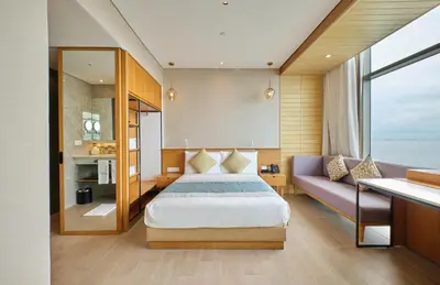 a bedroom with a bed and a couch at Hotel H2O in Manila
