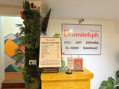 a room with a table with a sign on it at Dormitelsph España in Manila