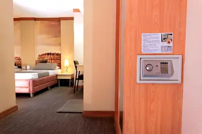 a room with a bed and a room with a microwave at Eurotel Makati in Manila
