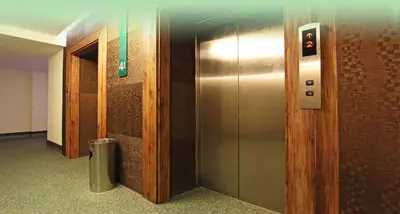 a elevator in a building with a metal door at Eurotel Makati in Manila