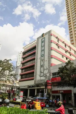 a building with a sign on the side of it at Eurotel Pedro Gil in Manila
