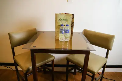 two bottles of water on a table with chairs at Eurotel Pedro Gil in Manila