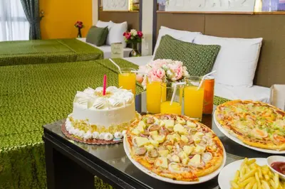 a table with two plates of food and a cake at Eurotel Pedro Gil in Manila