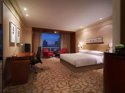 a hotel room with a bed and a desk at New Coast Hotel Manila in Manila