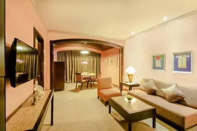 a living room with a couch and a table at Makati Palace Hotel in Manila