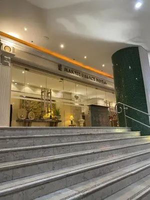 a building with stairs in front of a market market hotel at Makati Palace Hotel in Manila
