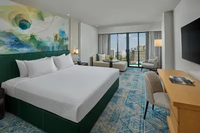 a hotel room with a bed and a desk at The Heritage Hotel Manila in Manila