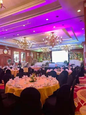 a banquet hall with tables and chairs and a projection screen at The Heritage Hotel Manila in Manila