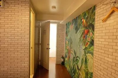 a hallway with a painting of a bird on the wall at Spaces Hotel Makati in Manila