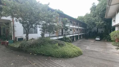 an empty parking lot in front of a building at RedDoorz at Broadway Court Apartelle Quezon City in Manila