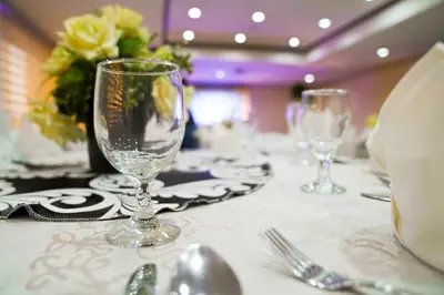 a table with two wine glasses on top of it at Berjaya Makati Hotel in Manila