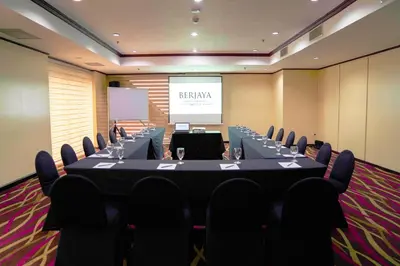 a meeting room with a long table and chairs at Berjaya Makati Hotel in Manila