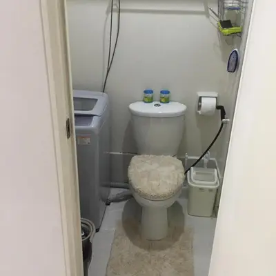 a small bathroom with a toilet and a sink at Luxury Condo-Princeton Residence-New Manila Quezon City-Fast Wi-fi150mbps in Manila