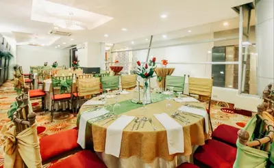 a dining room with a table and chairs at Greenhills Elan Hotel Modern - Newly Renovated in Manila
