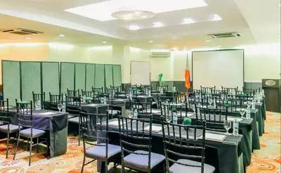 a room with rows of tables and chairs at Greenhills Elan Hotel Modern - Newly Renovated in Manila