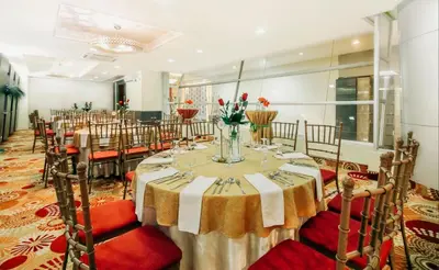 a banquet hall with a long table with red chairs at Greenhills Elan Hotel Modern - Newly Renovated in Manila