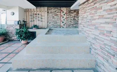 a set of concrete steps in front of a brick wall at Greenhills Elan Hotel Modern - Newly Renovated in Manila