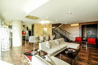 a living room with a couch and a table at Greenhills Elan Hotel Modern - Newly Renovated in Manila