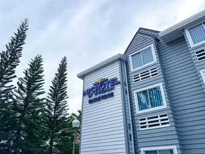 a sign on the side of a building at Microtel by Wyndham Eagle Ridge in General Trias