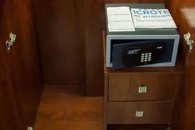 a microwave sitting on top of a wooden cabinet at Microtel by Wyndham Mall of Asia in Manila