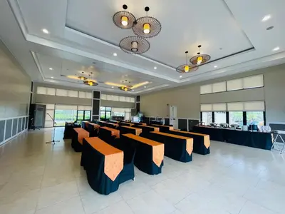 a large room with chairs and tables in it at Aquamira Hotel & Resort in Tanza