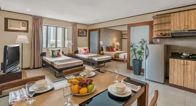 a kitchen and living room with a table with fruit on it at Hotel Kimberly Manila in Manila