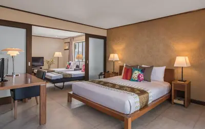 a hotel room with a large bed and a desk at Hotel Kimberly Manila in Manila