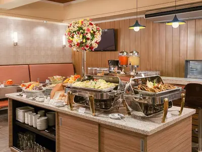 a buffet line with food in a hotel room at Hotel Kimberly Manila in Manila