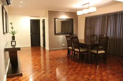 a dining room with a table and chairs at Copacabana Apartment Hotel in Manila