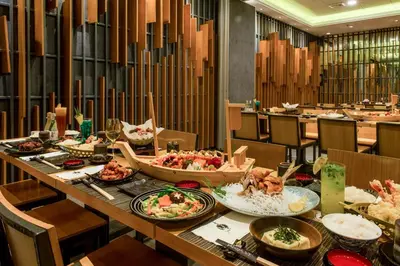 a long table with plates of food in a restaurant at Astoria Plaza in Manila