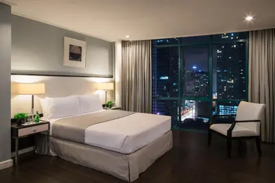a hotel room with a bed and a window at Astoria Plaza in Manila