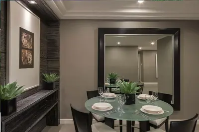 a dining room with a table and a mirror at Astoria Plaza in Manila