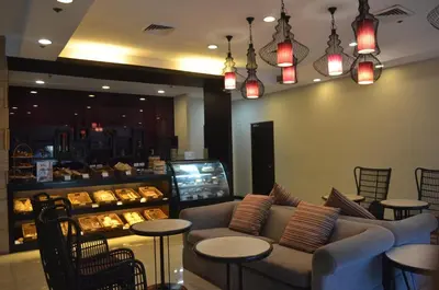 a restaurant with a couch and tables and a bakery at El Cielito Inn - Sta. Rosa in Santa Rosa