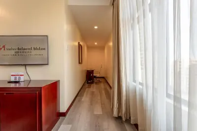 a long hallway with a window and a podium at Swiss-Belhotel Blulane in Manila