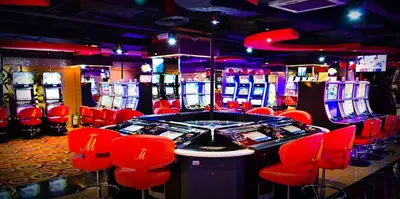 a casino with red chairs and video game machines at Networld Hotel Spa and Casino in Manila