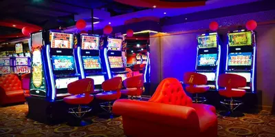 a casino with red chairs and slot machines at Networld Hotel Spa and Casino in Manila