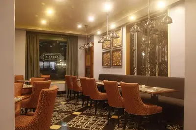 a restaurant with a long table and chairs at Herald Suites Polaris in Manila