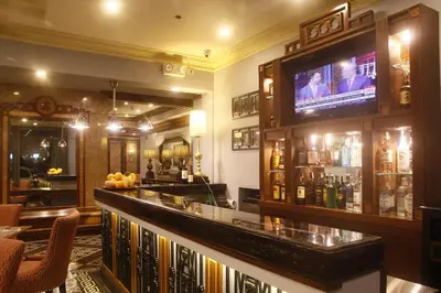 a bar with a television on top of it at Herald Suites Polaris in Manila
