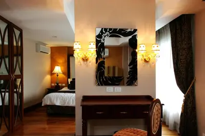 a bedroom with a bed and a mirror on the wall at Hotel Celeste Makati in Manila