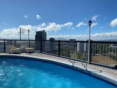 a swimming pool on the roof of a building at Parque España Residence Hotel in Manila