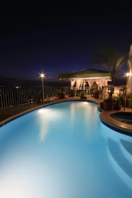 a large swimming pool lit up at night at Parque España Residence Hotel in Manila