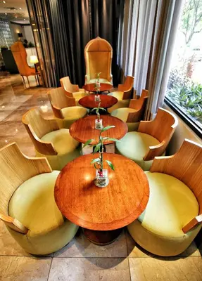 a group of tables and chairs in a room at Parque España Residence Hotel in Manila