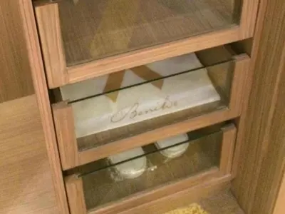 a wooden cabinet with a glass door with the word buffet at Hotel Benilde Maison De La Salle in Manila