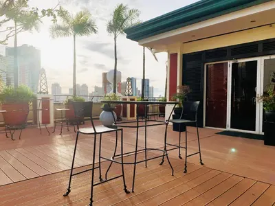 a balcony with a table and chairs on a building at Hotel Benilde Maison De La Salle in Manila