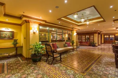 a lobby with a couch and chairs in a building at Herald Suites in Manila