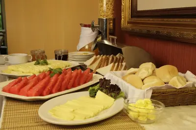 a table topped with plates of cheese and bread at Herald Suites in Manila