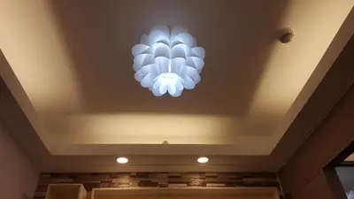 a chandelier on the ceiling of a room at Breeze Residences by CS Luxe in Manila